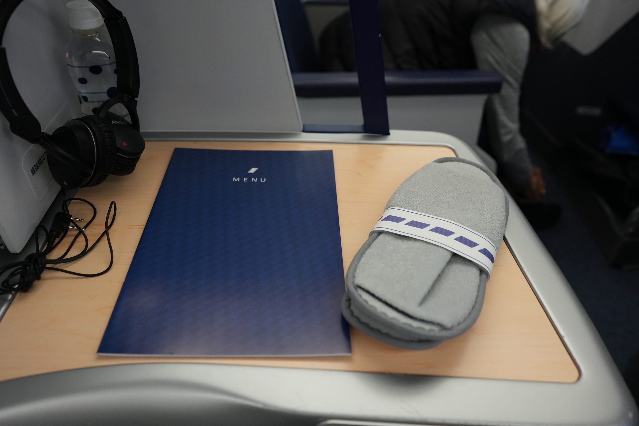 Inflight meal menu and slippers provided on ANA Business Class